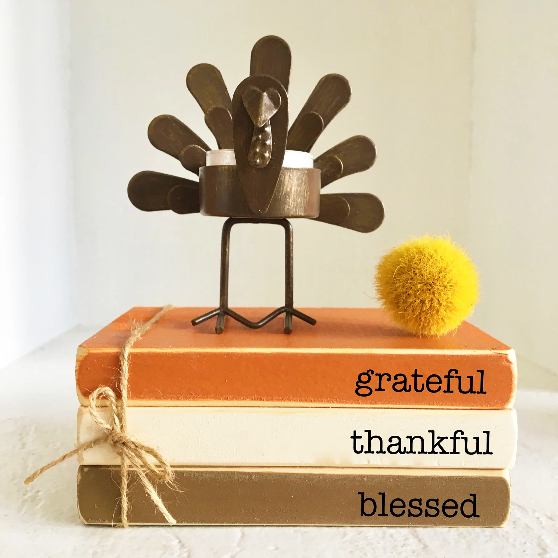 Create a warm Thanksgiving atmosphere with our wooden book stack decor.